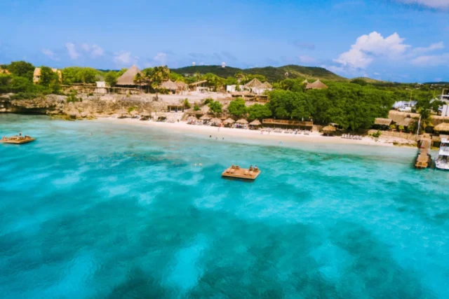 Aerial drone view of Playa Kalki beach in Curacao with turquoise water and a beachfront resort