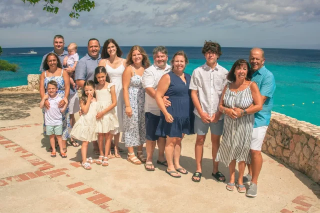 Large family group posing together on a beach in Curacao
