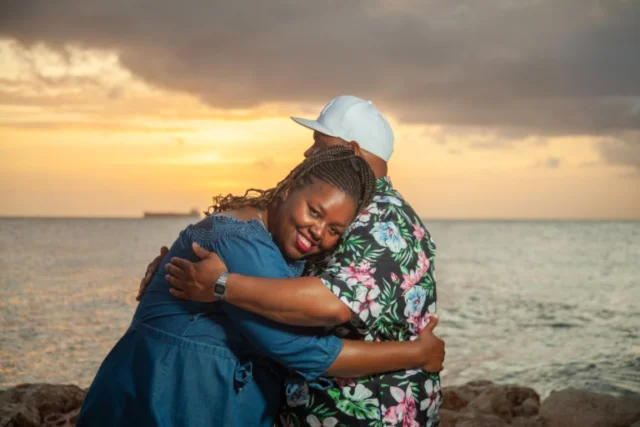 Couple embracing on the beach at sunset in Curacao
