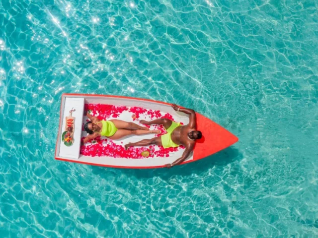 Couple lying together on a flower-decorated boat in Curacao